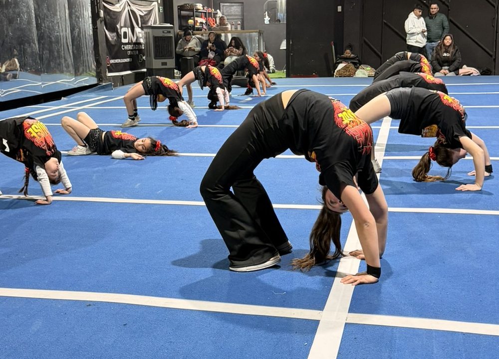 Deportistas de Firehouse trabajando puentes y técnica de suelo durante la clase de gimnasia